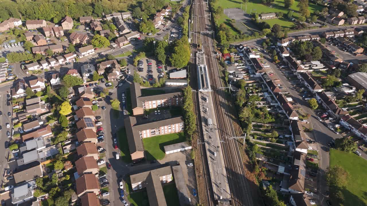 Bird's eye view of Burnham station complex with platforms, parking facilities and surrounding residential neighborhoods in Slough, Berkshire, UK