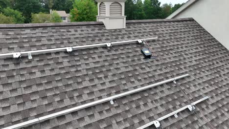 solar panel mounting rails on residential shingle roof