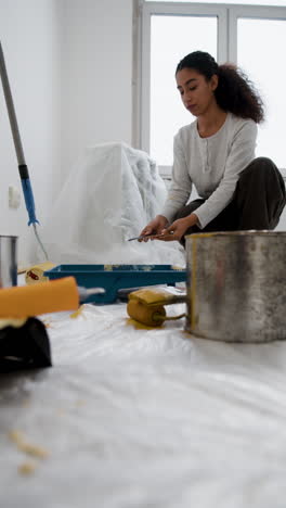 young woman painting a room