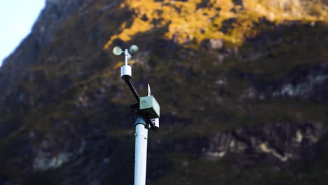 automatic weather station with weather monitoring system, against majestic mountain range of new zealand