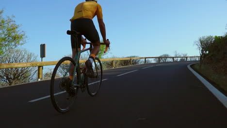 engaging in outdoor exercise, a man cycles on a quiet morning road with his road bike. the slow-motion recording highlights the excitement of extreme sports