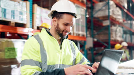 warehouse worker using laptop for inventory management