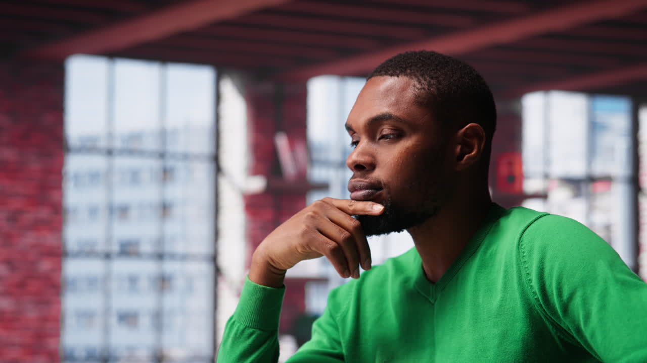 Vertical Video Black teleworker being pensive thinking about solutions to make more money