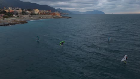 kite surfer gliding on the blue sea waters off the coast of genoa, italy at dusk, serene ocean scene