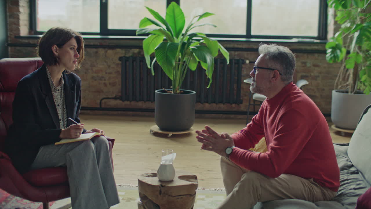 Female Therapist Speaking with Male Client during Counseling Session