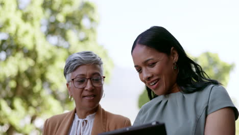 Tablet,-talking-and-walking-with-a-business-woman