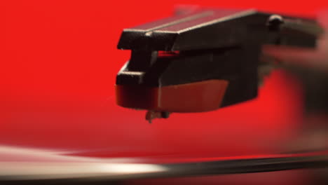 slider move on a red retro record players needle dropping on to a vintage vinyl music album, right to left