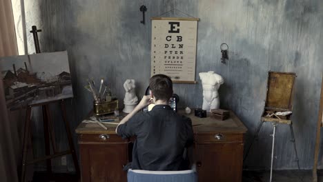 artist working in a vintage-style studio