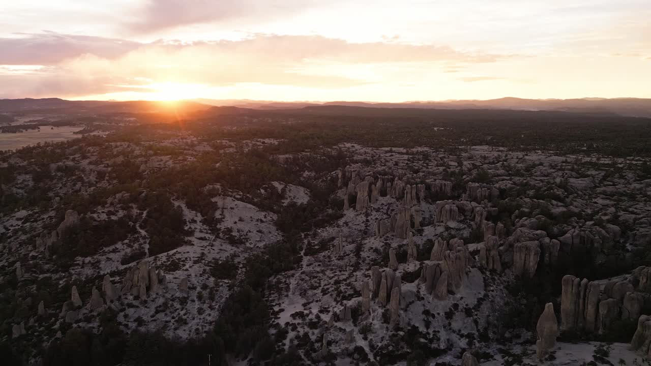 Majestic aerial shot of the Valle de los Monjes in Chihuahua, showcasing the unique rock formations and sunset glow