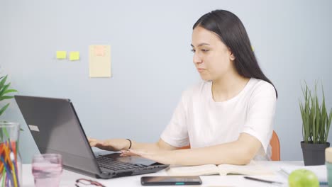 female student chatting with beloved on laptop.