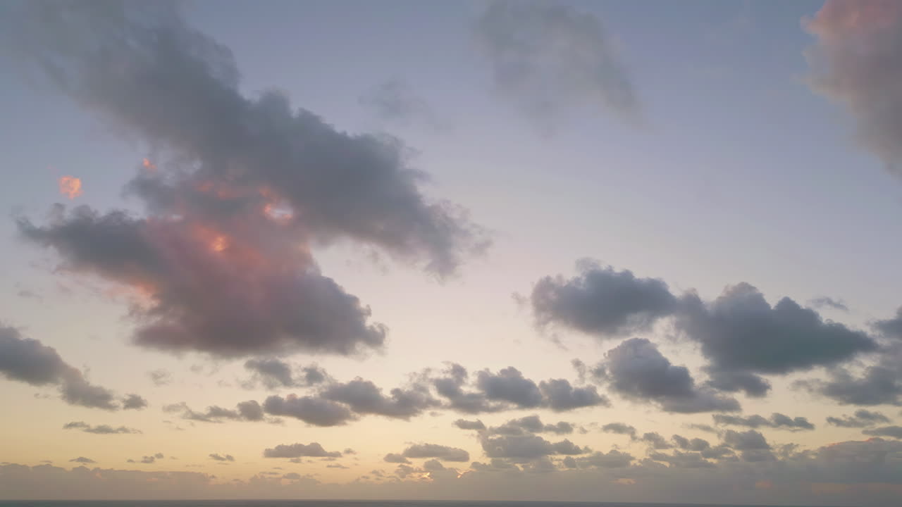 Stunning evening sky aerial view. clouds lit by orange sunset light.