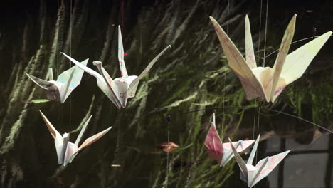 six orizurus - paper birds fly over the water of a lake