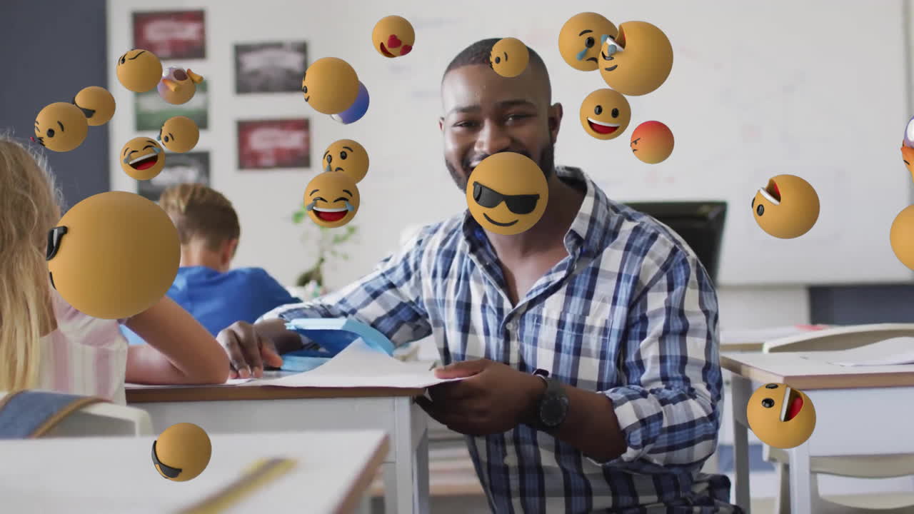 Animation of emoji icons over diverse schoolchildren and teacher