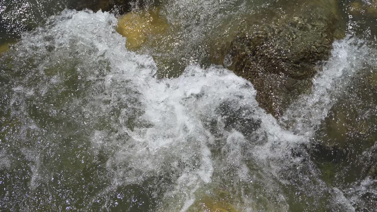 Water is flowing through a mountain torrential river.