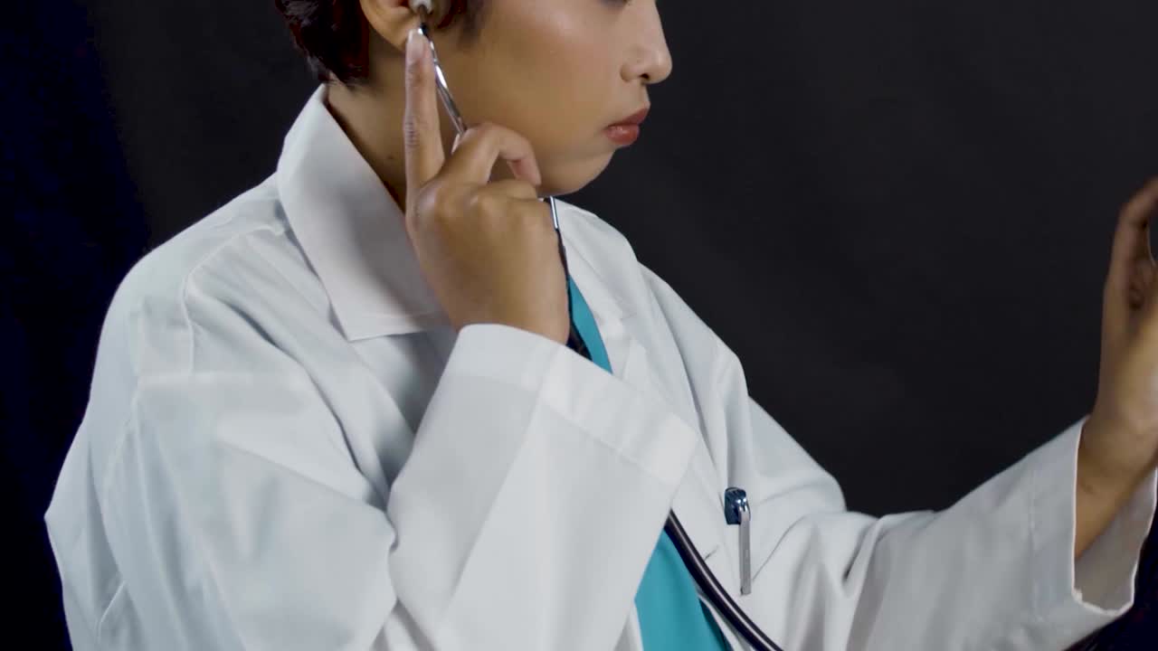 Tight framing of a female doctor or nurse examining a patient with a stethoscope