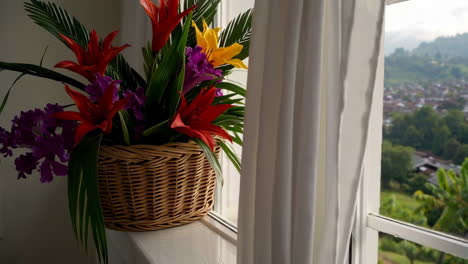 flowers in a basket at a window