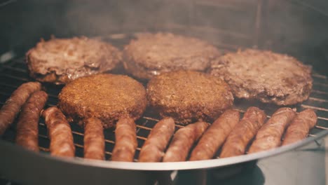 close-up-shot-grilled-sausages-burgers-and-vegan-burgers-outdoors