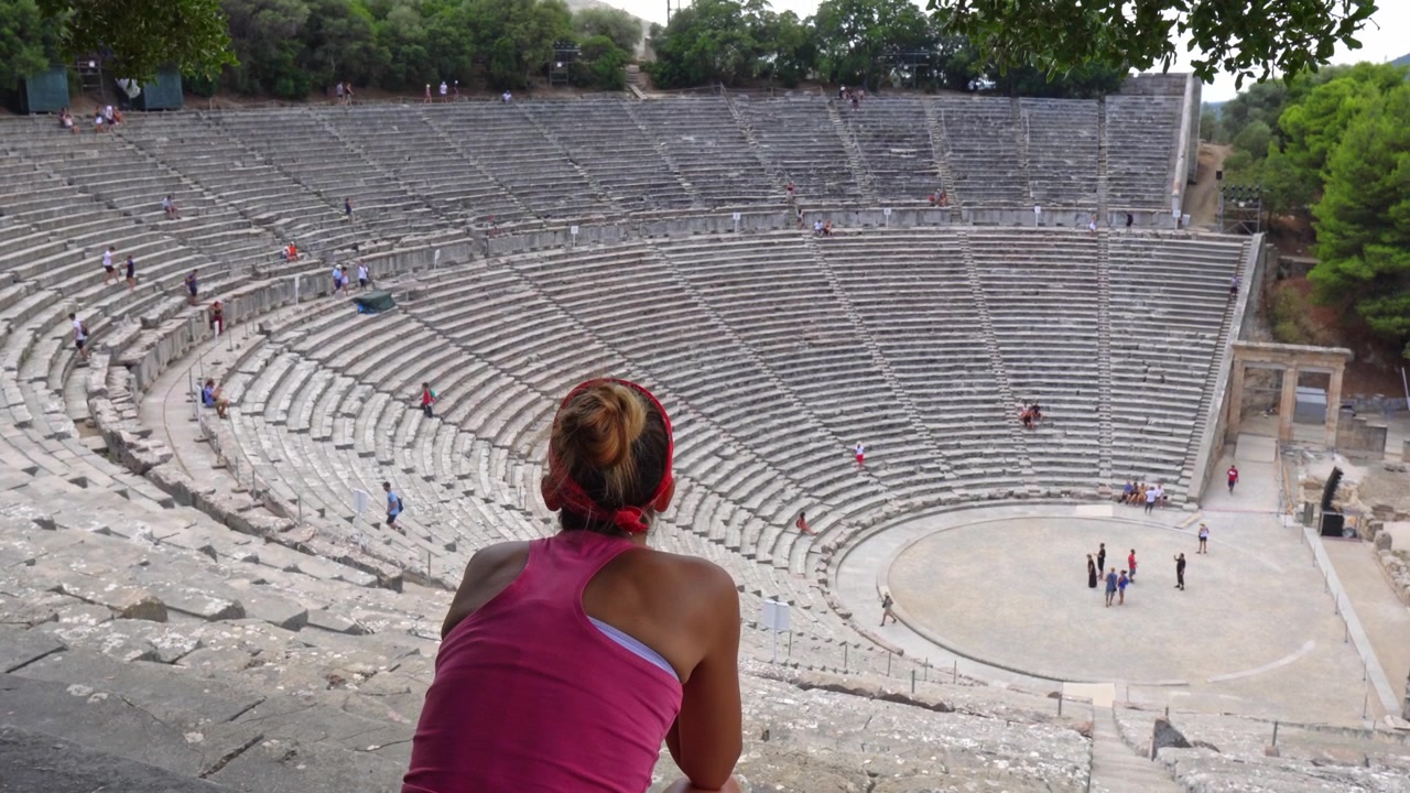 Young woman enjoying the ancient Theatre of Epidaurus in Greece