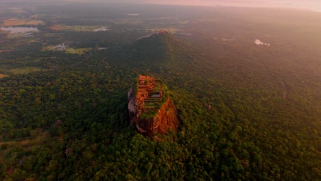 soaring above the misty jungles of sri lanka, this drone clip captures the iconic sigiriya rock at sunrise.