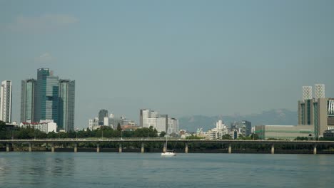 Hangang-River-with-Day-Traffic-on-Gangbyeon-Expressway-Road-and-Mapo-gu,-Seoul-Bukhansan-Mountains-in-Background