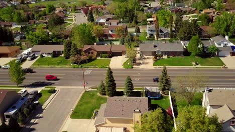 a floating drone shot over a main road in the suburbs part of utah