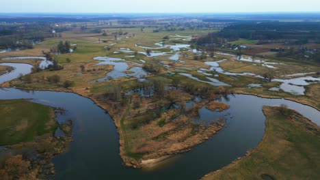 spring aerial footage of flooded fields and meandering streams in the countryside