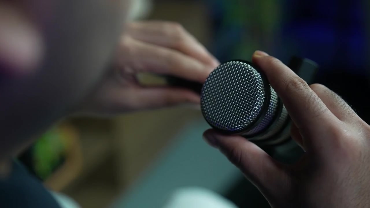 Close up of podcast microphone swinging into position in professional recording studio
