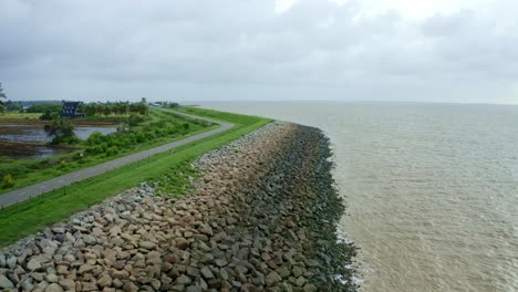 Aerial:-Sea-dyke-view-along-the-road-flyover-with-North-Atlantic-Ocean-and-Nickerie-Suriname