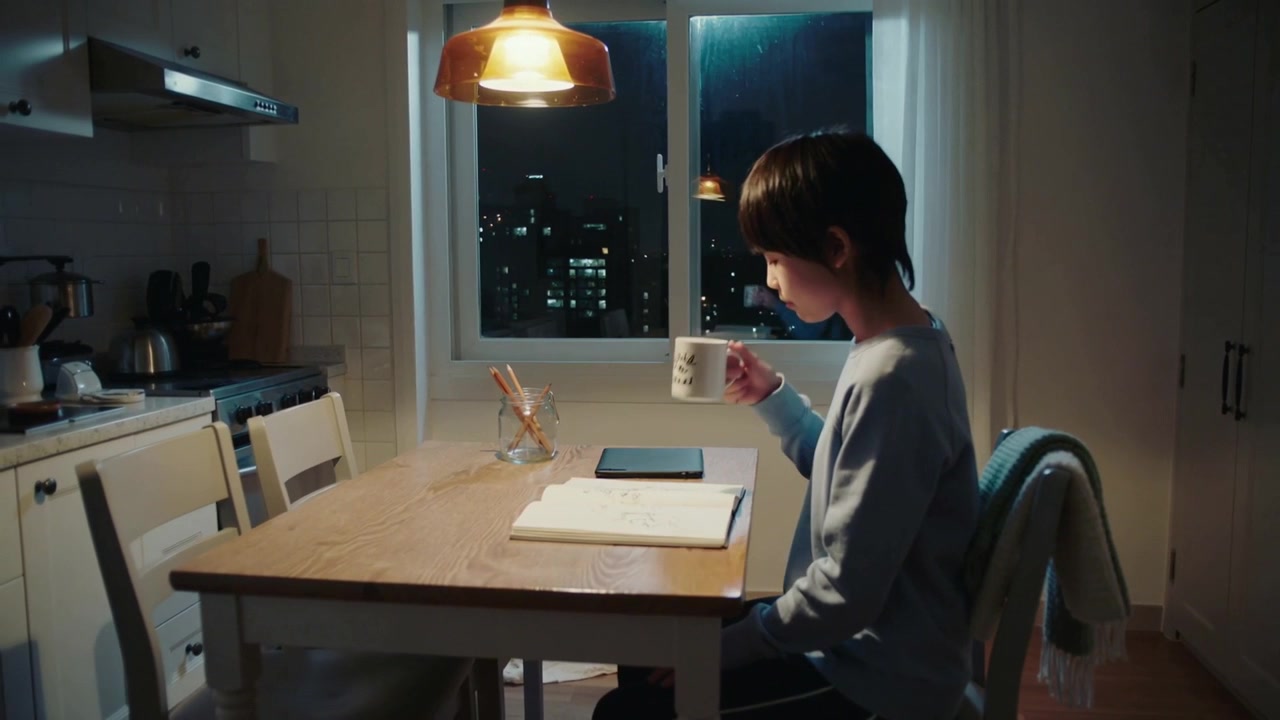 Sipping teen in casual clothes at home placing mug, studying notebook to finish homework