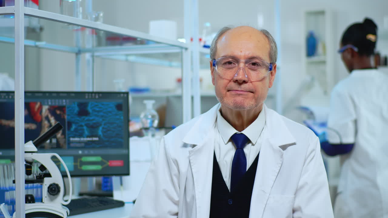 Portrait of senior experienced scientist man smiling at camera