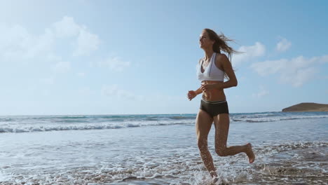 running woman, female runner jogging during outdoor workout on beach., fitness model outdoors.