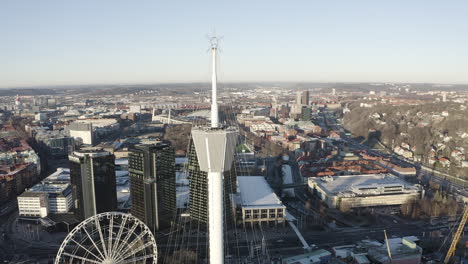 Drone-shot-close-up-of-a-watch-tower-at-the-swedish-amusement-park-Liseberg-in-Gothenburg,-Sweden