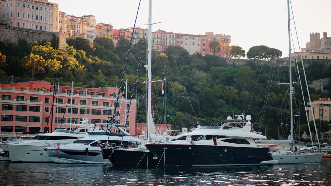La Condamine, Monaco - October 4, 2024: View of boats docked in the Monaco Marina with the skyline of the city on the background