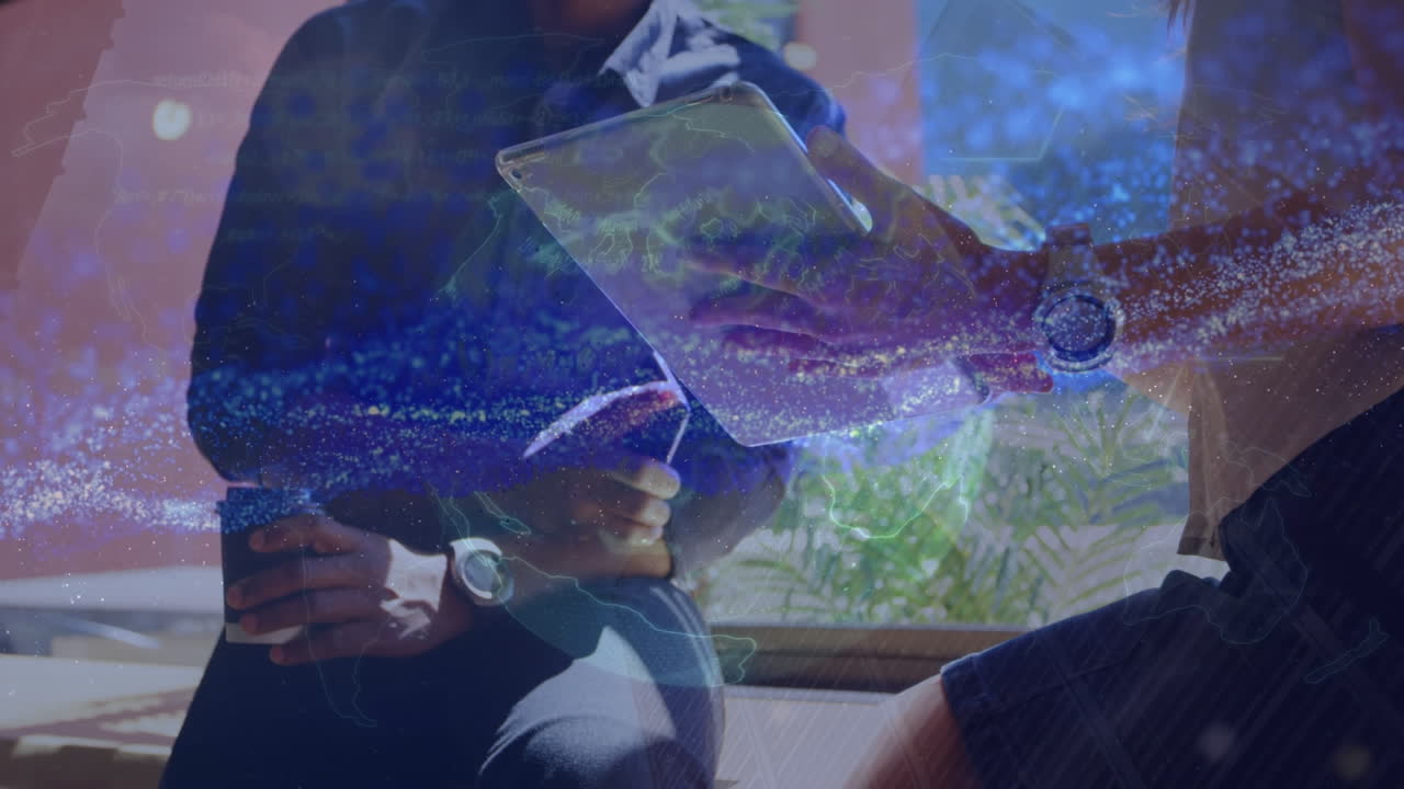 Animation of data processing and globe over caucasian business people using tablet