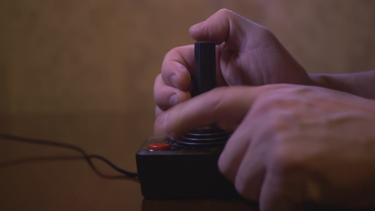 Man Plays With Vintage TV Video Game Joystick. 4K Footage