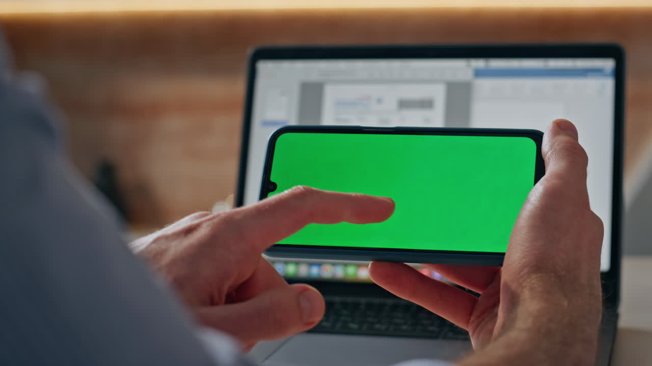 Man hand touching chroma key screen chat desk closeup. Freelancer tapping cell