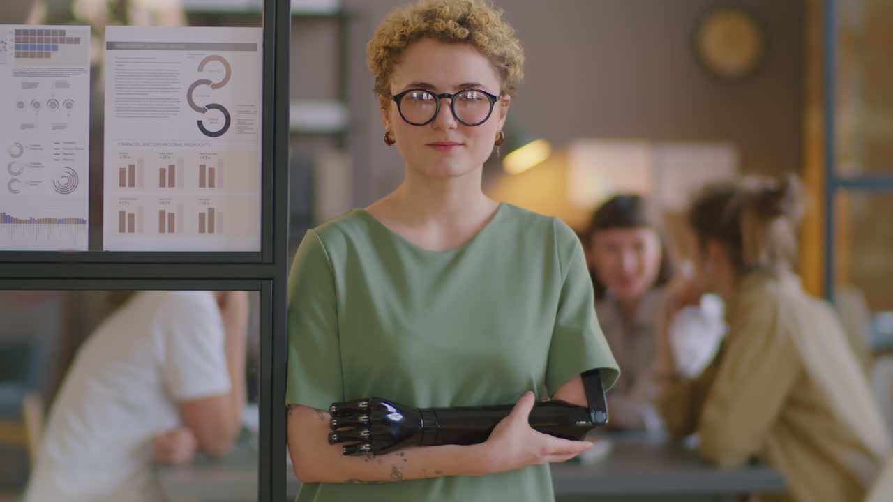 Businesswoman with Prosthetic Arm Posing on Camera in Office