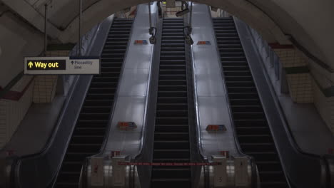 london city lockdown piccadilly circus tube subway underground station empty and abandoned during 2020 coronavirus pandemic with empty moving escalators