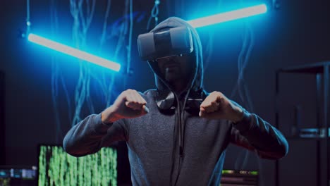 anonymous man in vr glasses having headset and virtual reality tour, while dancing in the dark room with neon lamps and wires