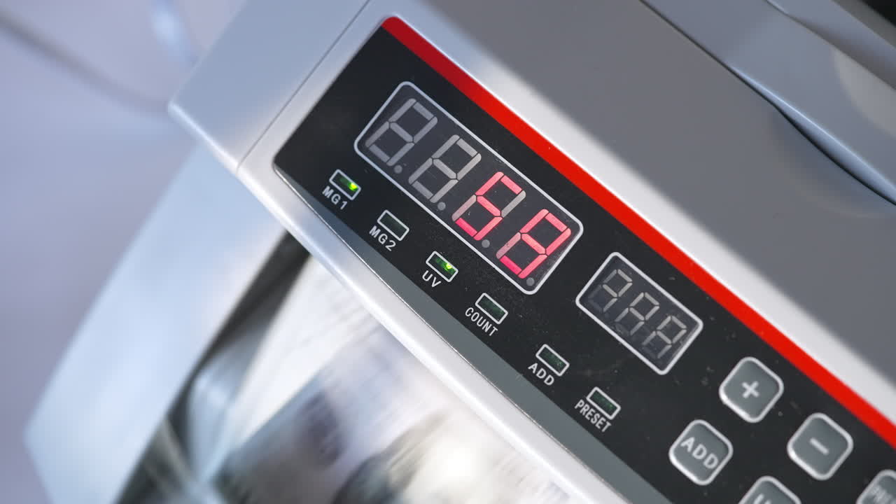 Electronic cash counting equipment working. Unrecognized banknotes turning quickly in machine. Close up.