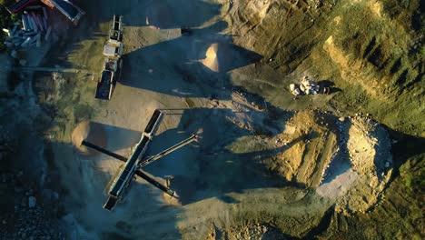Linear overpile portal reclaiming dirt machine chutes spread piles, top down side to side drone aerial
