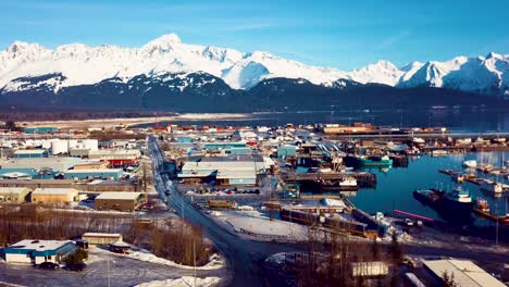 4K-Drone-Video-of-Seward-Boat-Harbor-and-Surrounding-Snow-Covered-Mountains-on-Snowy-Winter-Day-in-Alaska