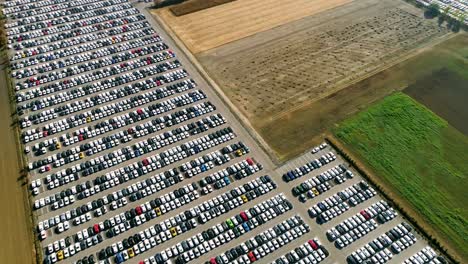 Aerial-footage-of-finished-cars-ready-to-be-shipped-on-huge-distribution-center