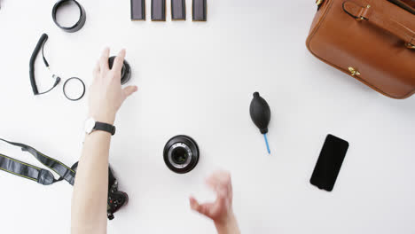 top view photographer cleaning lens working at desk from above - red epic dragon