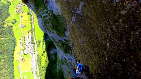 a man taking slow steps down a rock