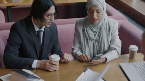 business colleagues discussing in a cafe