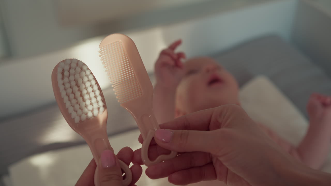 Gentle grooming of newborn baby hair with soft brush and comb in crib promoting hygiene comfort and
