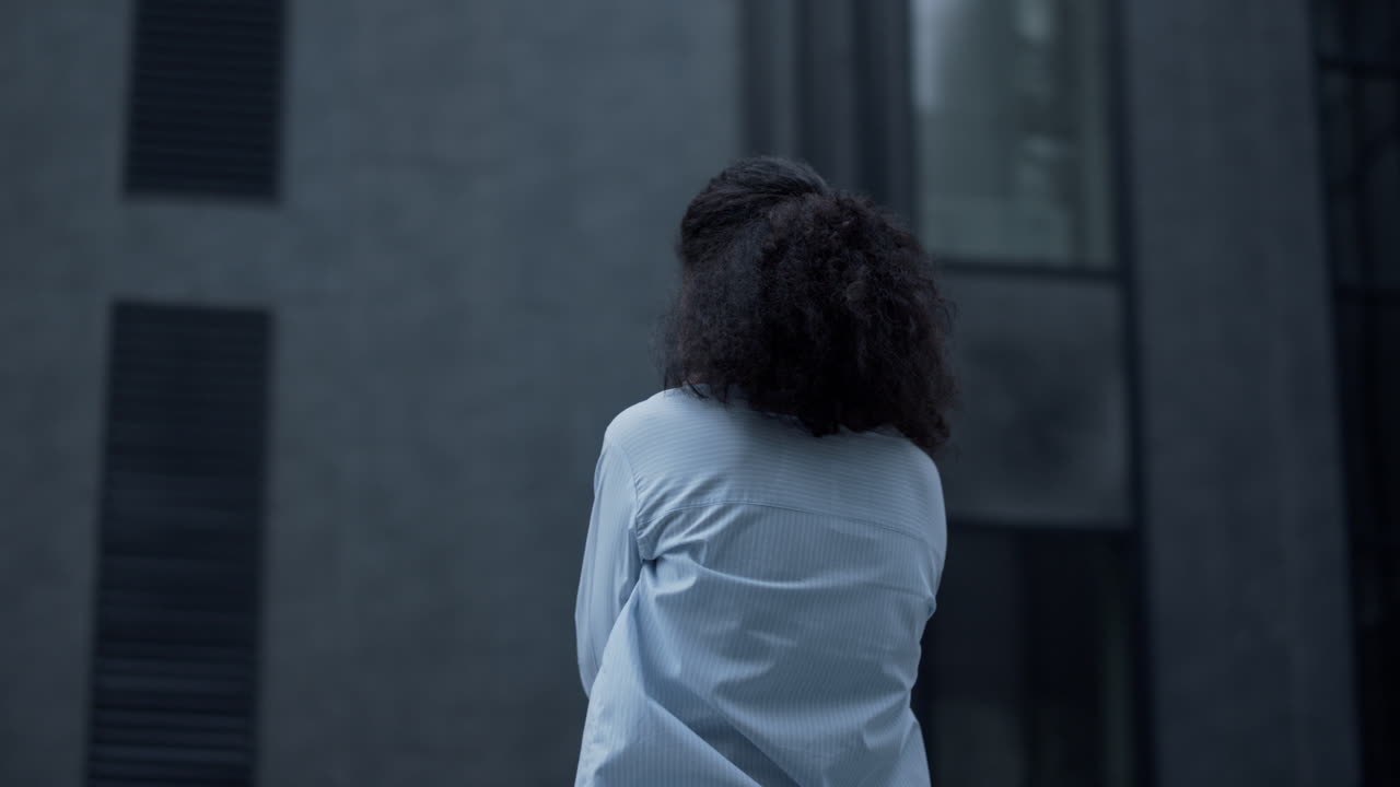 Depressed businesswoman crying at office building. Portrait of disappointed girl