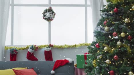Animation-of-snow-falling-over-christmas-tree-and-christmas-stockings-in-background