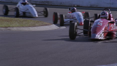 cars race around a sharp turn